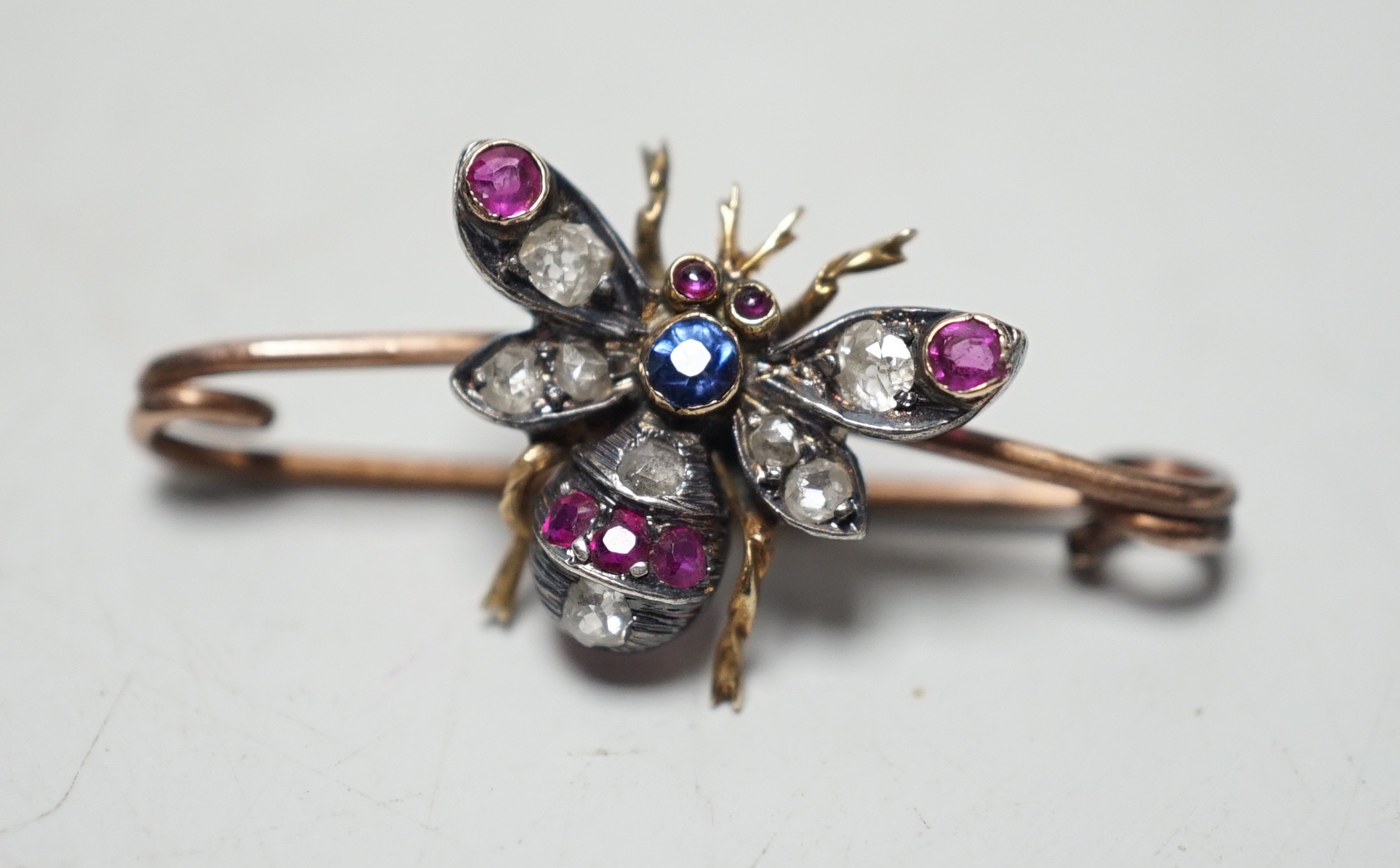 A late Victorian yellow metal, ruby, sapphire and diamond set bug brooch, 30mm, gross weight 2.2 grams.